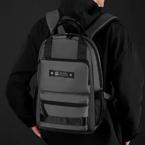 Minimalist matte dark grey waterproof commuter backpack with multiple zipper layers