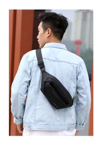 Close-up of black waterproof nylon crossbody chest bag with adjustable strap on model