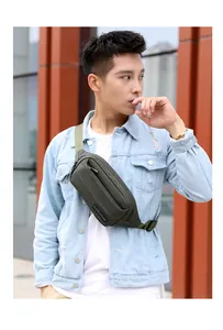 Adjustable dark green nylon outdoor waist bag worn as a crossbody pack for men