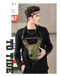 Detailed view of dark green tactical chest bag with orange accents and utility pockets