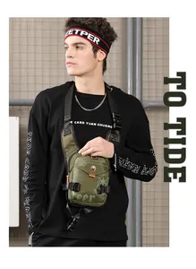 Detail of army green nylon chest bag featuring functional buckles and orange drawstring accents