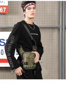Detail of army green tactical chest bag with multiple pockets and durable buckles