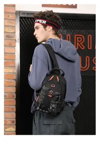Detail of waterproof black nylon chest bag featuring orange zippers and street fashion style