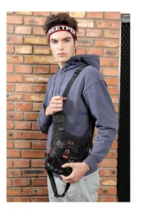 Detail of waterproof nylon tactical leg bag with orange drawstrings and street style prints