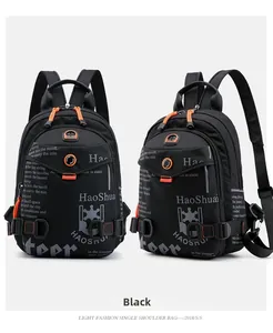 Detail of waterproof black nylon chest bag with vibrant orange zipper pulls and dual strap view