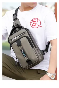 Outdoor shot of a sage green nylon crossbody chest bag with functional zippers
