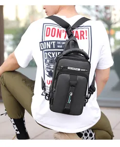 Rear view of a black tactical chest bag with USB charging port and adjustable strap