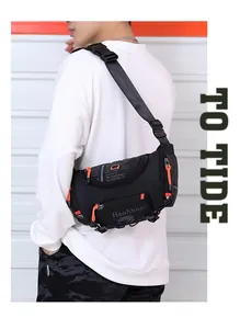 Detail of waterproof nylon waist bag with orange zipper pullers on a male model