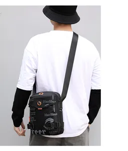 Detailed back view of a black nylon waterproof crossbody bag with buckle straps