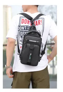 Detail of matte black tactical chest bag showing durable handle and waterproof fabric