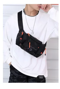 Close-up of durable black nylon outdoor bag with vibrant orange zipper pull details