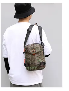 Detailed back view of a jungle camouflage crossbody bag with durable nylon strap
