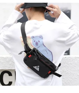 Close-up of the ultra-slim black oxford fabric chest bag with TOUGH SLHS brand patch