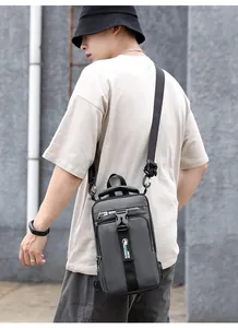 Detail of dark grey multi-compartment sling bag with USB port and adjustable buckle strap