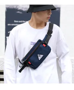 Close-up of dark blue canvas chest bag for men with TOUGH SLHS logo and red buckles