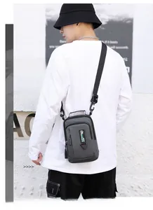 Detailed view of the water-resistant nylon chest bag showing multiple zipped compartments