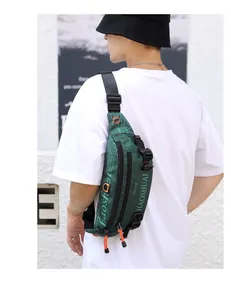 Detail of army green waterproof canvas waist bag with orange zipper and adjustable strap