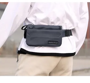 Close-up of durable navy nylon sports waist bag with adjustable strap on a male model