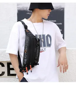 Detail of black outdoor chest bag with multiple zippers and bright orange pull cords