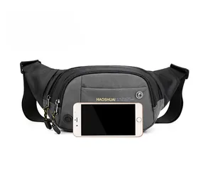 Detail view of gray ripstop nylon waist bag with earphone port and phone storage