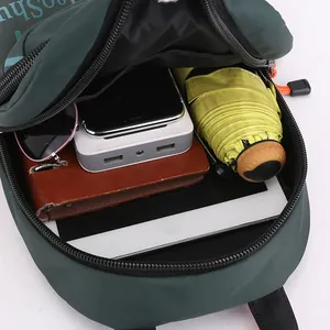 Waterproof nylon crossbody bag in dark green showing large capacity for tablet and items