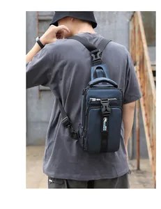 Detail of dark blue waterproof sling bag showing the adjustable strap and buckles