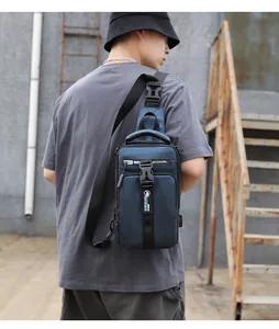 Detail of navy blue crossbody chest bag showing side USB charging port and durable nylon texture