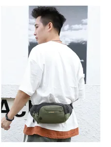 Detail of army green waterproof nylon waist bag with multiple zippers and buckle straps