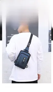 Detail of dark blue waterproof nylon chest bag with adjustable strap and brand patch