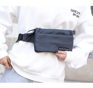 Close-up of waterproof grey-blue chest bag with adjustable strap and brand logo