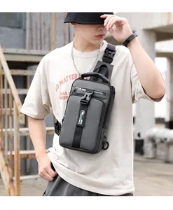 Detail view of dark grey waterproof oxford chest bag with buckle and USB port