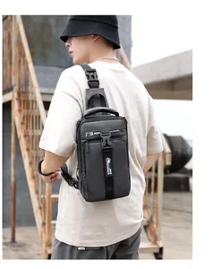 Outdoor lifestyle shot of black nylon crossbody bag with buckle and brand logo