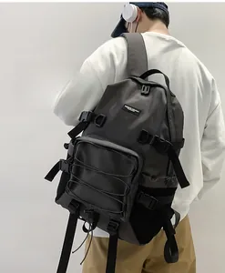 Detail of dark gray water-resistant nylon backpack with tactical straps and buckles