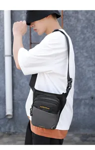 Outdoor model wearing a black and gray multi-pocket tactical drop leg and chest bag