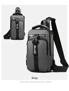 Detailed view of grey waterproof men's sling bag featuring USB port and logo strap