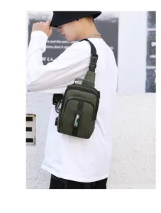Close-up of olive green crossbody chest bag showing nylon texture and brand strap detail
