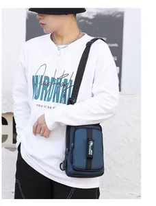 Detail of navy blue men chest bag showing USB charging port and vertical zipper pocket