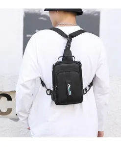 Detail view of multifunctional black crossbody bag featuring integrated USB charging port