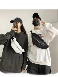 Waterproof chest bag close-up showing black and white techwear styles on male and female models