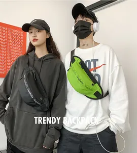 Close-up of trendy waterproof waist bags in black and neon green with adjustable straps