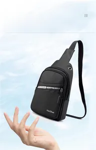 Close-up of black crossbody chest bag featuring side earphone port and durable fabric