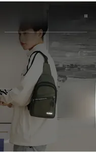 Detail showing the reflective brand logo on a durable nylon olive green crossbody chest bag