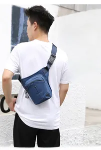 Detail showing deep blue nylon leg bag with zippers and buckle straps worn by a model