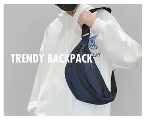 Close-up of navy blue ballistic nylon chest bag worn over a white casual hoodie