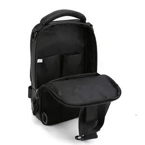 Black nylon chest bag with USB charging port showing interior pockets and dual zippers