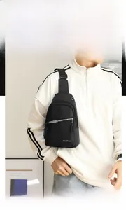 Close-up of a men's black waterproof nylon chest bag with adjustable strap and metal zippers