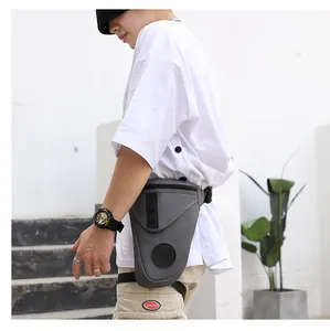 Detail view of grey tactical leg bag with waterproof fabric and adjustable straps on model