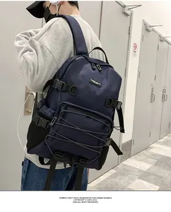 Detail of navy blue high-density nylon chest pack with bungee cord system and mesh side pocket