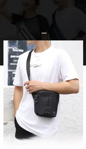 Detail of a black outdoor drop leg bag with tactical drawstring and waterproof nylon