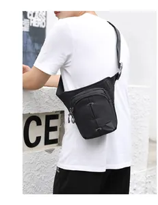 Detail view of black nylon multi-pocket drop leg bag with adjustable buckle strap
